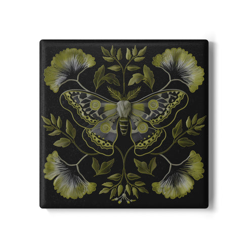 Square black ceramic coaster featuring a detailed chartreuse luna moth illustration surrounded by symmetrical botanical elements including ginkgo-inspired leaves and delicate foliage.